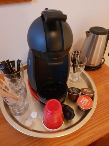 a coffee maker on a plate on a table at Boetiek Hotel Marum in Marum