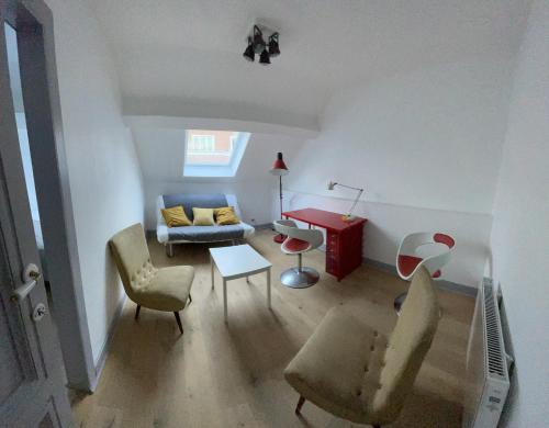 a living room with a couch and chairs and a table at Le VILLAGE d'EZRA in Brussels