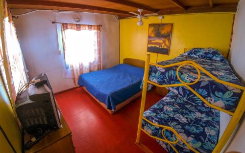 a room with two bunk beds and a window at La Casa del Sol Naciente in San Pedro de Atacama