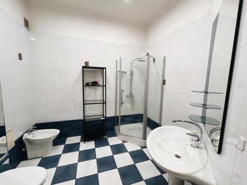 a bathroom with a toilet sink and a shower at Kyiv Gallery Apartment in Kyiv