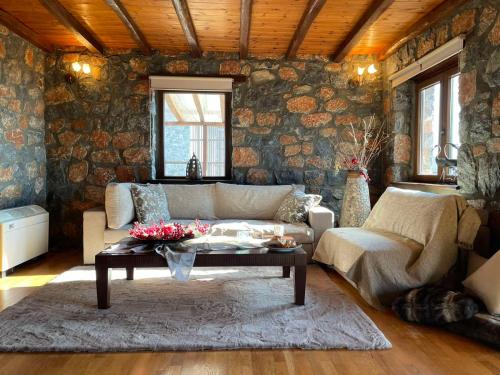 a living room with a couch and a table at Chalet D'elite in Palaios Agios Athanasios