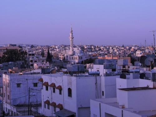 a view of a city with a clock tower at Pilgrim's Guest House in Madaba