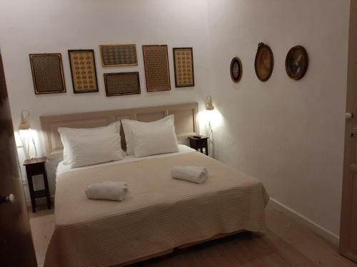 a bedroom with a bed with two towels on it at En Patmo Holiday Home in Patmos