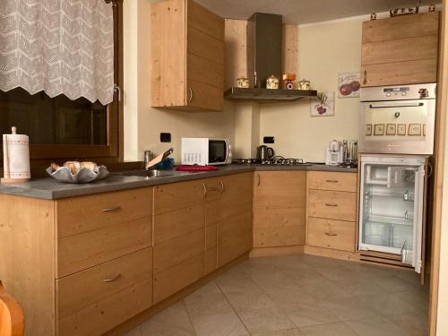 a kitchen with wooden cabinets and a stove top oven at Casa Lina S. Pietro in San Pietro