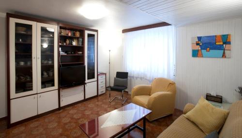 a living room with a couch and chairs and a television at Sobe pri Anici in Koper