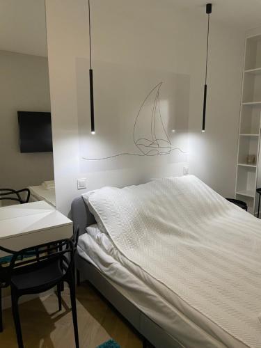 1 dormitorio con 1 cama, 1 mesa y 1 silla en Śledź Gdynia - YACHT PARK, en Gdynia