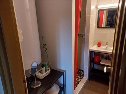 ein kleines Bad mit einem Waschbecken und einem Spiegel in der Unterkunft Háromfenyő Apartman in Révfülöp