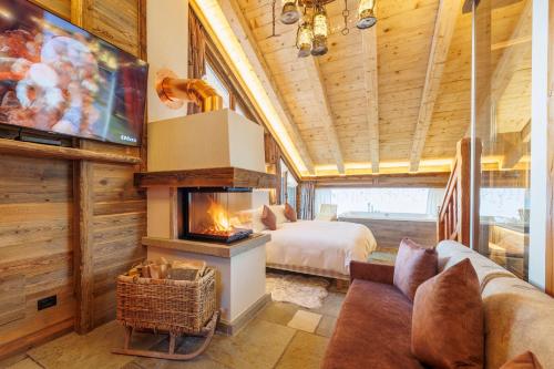 a living room filled with furniture and a fireplace at Park Chalet Village in Livigno