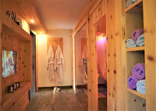 a room with a hallway with wooden walls and shelves at Der Trueferhof in Ehrwald