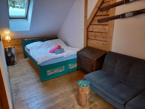 a small room with a bed and a couch at Good Bye Lenin Hostel Zakopane in Zakopane