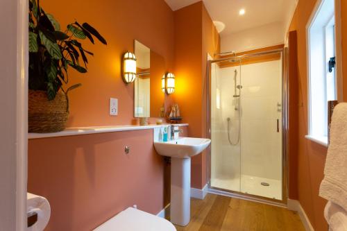 a bathroom with a sink and a shower at Pounce Hall -Stunning historic home in rural Essex in Saffron Walden
