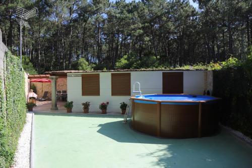 a swimming pool in a yard with a building at Casa Vazquez Sanxenxo La Lanzada in O Grove