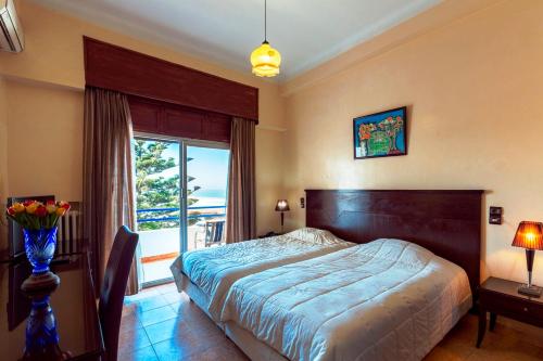 a bedroom with a bed and a large window at Hotel Bellerive in Casablanca