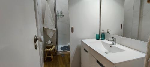 a white bathroom with a sink and a mirror at Stylish and Elegant Studio - Best View and Location in Coimbra Downton in Coimbra