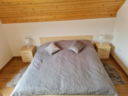 a bedroom with a bed with two night stands at Apartments Gaby in Gozd Martuljek