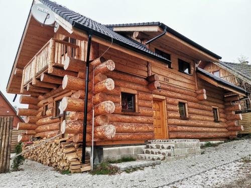 a log cabin with a staircase on the side of it at Kanadský zrub in Prievidza