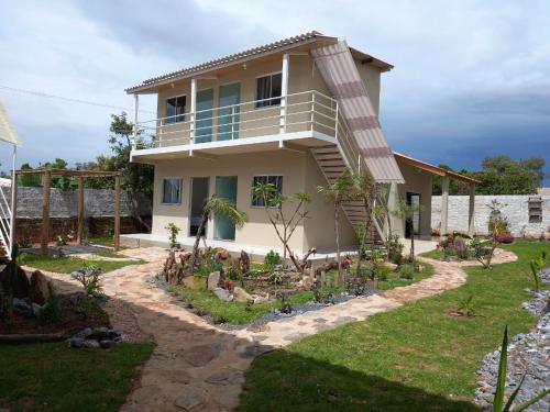 a house with a garden in front of it at Pousada Ostara in Alto Paraíso de Goiás