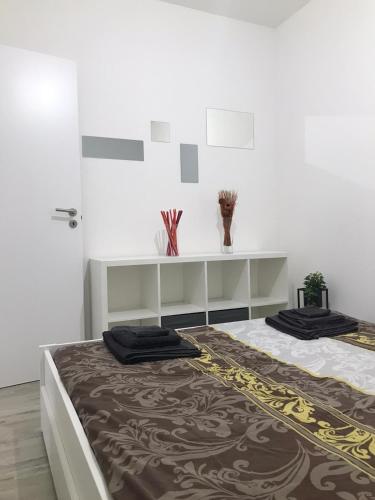 a bedroom with a large bed and a shelf at Mini Comfort House Udine in Udine