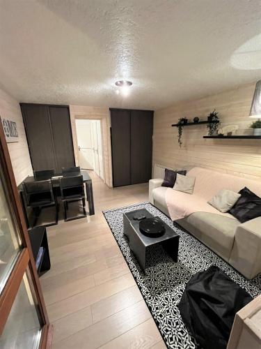 a living room with a couch and a table at Location appartement saint lary 2/4 personnes in Saint-Lary-Soulan