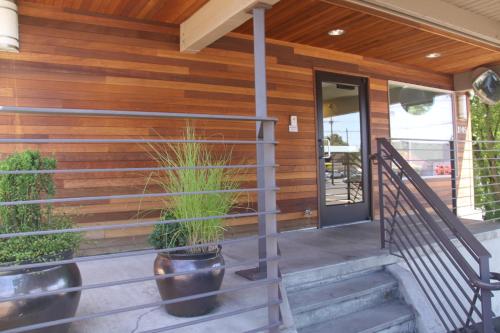 a porch of a house with a potted plant at Aladdin Inn and Suites in Portland