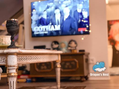 a table in a living room with a tv at Dragon’s Nest: Cozy & modern attic loft Nuremberg in Schwaig bei Nürnberg