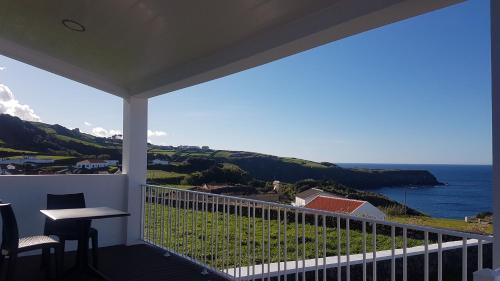 a balcony with a view of the ocean at Quinta Rico - House II in Praia da Vitória