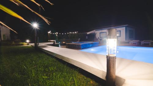 a swimming pool at night with a light on it at Quinta Rico - House II in Praia da Vitória