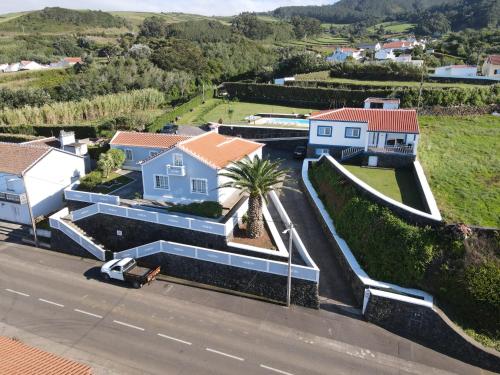 an aerial view of a house with a palm tree at Quinta Rico - House II in Praia da Vitória