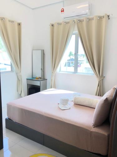 a bedroom with a large bed with a window at CASA IDAMAN - Islamic Homez in Melaka