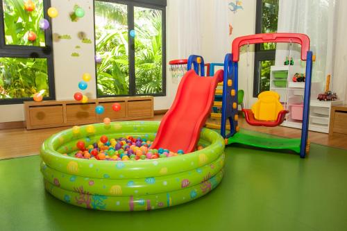 a childs play room with two play equipment at Raffles Hainan Clear Water Bay in Sanya