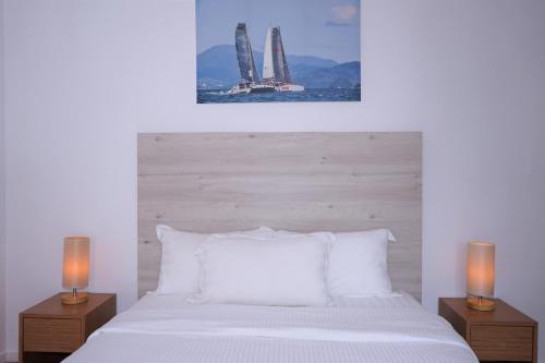 a bedroom with a white bed with two lamps at Ramada by Wyndham Langkawi Marina in Kuah