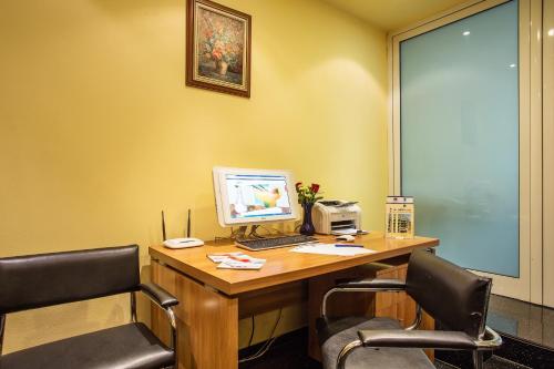 an office with a desk with a computer and two chairs at Europe Hotel in Sofia