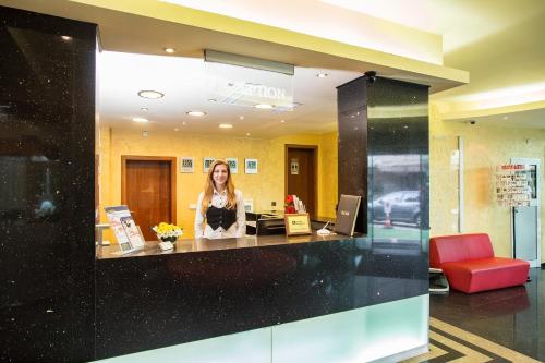 a woman standing at a counter in an office at Europe Hotel in Sofia