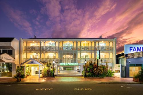 a large building with lights on at night at City Terraces Cairns in Cairns