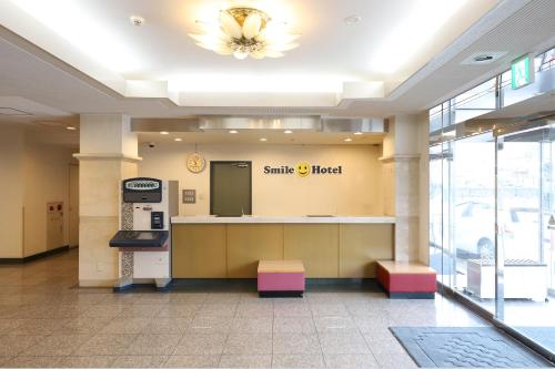 a santa clara hotel lobby with a smile hotel sign at Smile Hotel Takaoka Ekimae in Takaoka