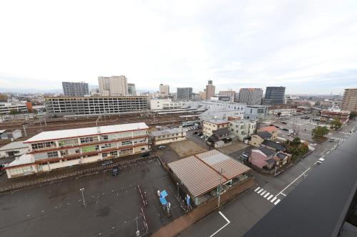 an overhead view of a city with buildings and a street at Smile Hotel Takaoka Ekimae in Takaoka