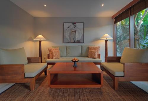 a living room with two couches and a coffee table at The Legian Seminyak, Bali in Seminyak
