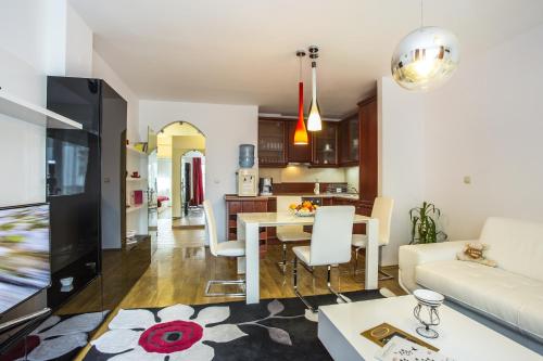 a living room with a couch and a table at Europe Hotel in Sofia
