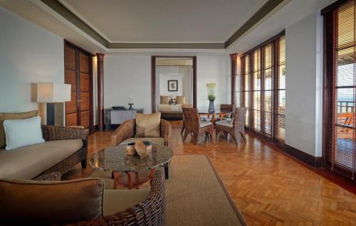a living room with a couch and a table at The Legian Seminyak, Bali in Seminyak