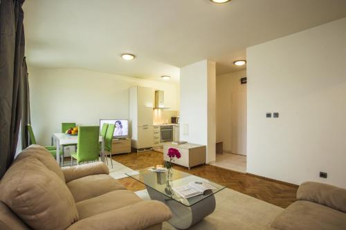 a living room with a couch and a table at Europe Hotel in Sofia