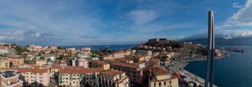 a city with buildings on a hill next to the water at Mare Fuori in Portoferraio