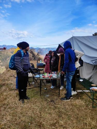 a group of people standing around a tent at Dhanaulti Camp Homes Retreat in Dhanaulti
