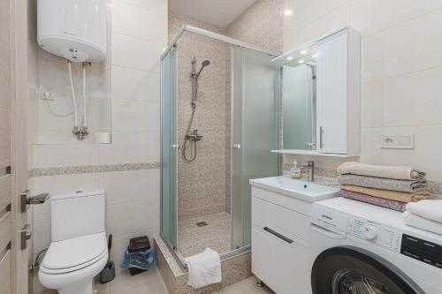 a bathroom with a shower and a toilet and a sink at 20 Deribasivska 2 bedrooms Apartment in Odesa