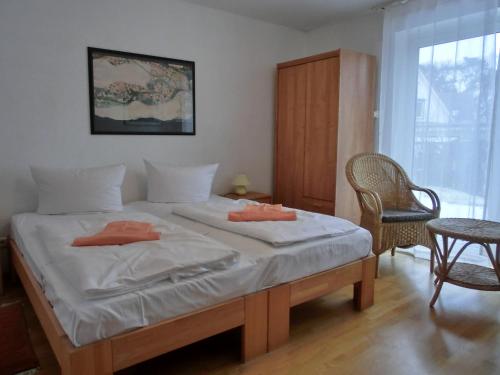 a bedroom with a large bed with two pillows on it at Ferienwohnung R3 in Graal-Müritz