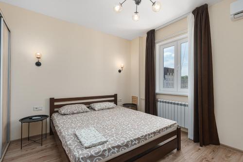 a bedroom with a bed and a window at 20 Deribasivska 2 bedrooms Apartment in Odesa