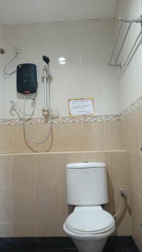 a bathroom with a toilet and a shower at Bee Garden & BB Motel - Alor Setar in Alor Setar