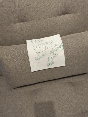 a piece of paper sitting on top of a couch at Alessi Suites & Studio in Mazzarino