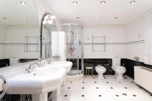 ein weißes Badezimmer mit 2 Waschbecken und einem WC in der Unterkunft Casa Blanca 4 in Benidorm