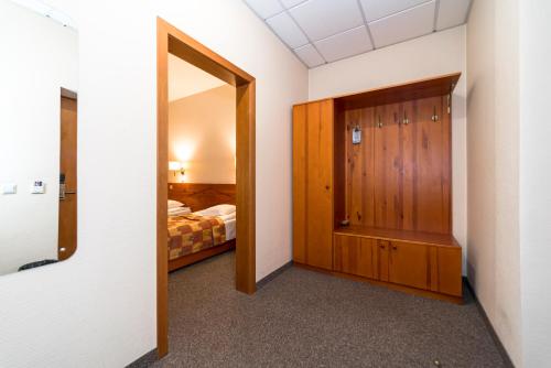 a room with a door leading to a bedroom at Kolonna Hotel Brigita in Rīga