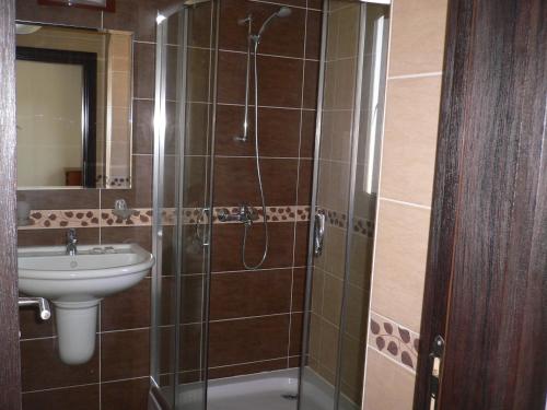a bathroom with a shower and a sink at Madara Club and Spa in Kosharitsa